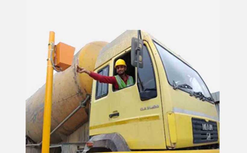 A truck driver operating an unmanned weighbridge.