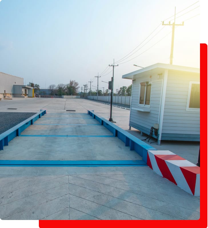 Giri Brothers' weighbridge platform with cabin and open area under clear sky.